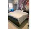 Cozy bedroom featuring a king bed with white blanket and an accent tapestry wall hanging at 10800 Us Highway 19 N # 143, Pinellas Park, FL 33782