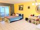 Comfortable bedroom features tiled flooring, a cozy bed, and sunny yellow walls for a cheerful ambiance at 10800 Us Highway 19 N # 143, Pinellas Park, FL 33782