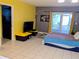 Relaxing bedroom with tiled floors and a sliding door which leads to outdoor space for seamless indoor-outdoor living at 10800 Us Highway 19 N # 143, Pinellas Park, FL 33782