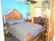 Bedroom featuring a bed with wooden headboard and eclectic colorful walls and decor at 10800 Us Highway 19 N # 143, Pinellas Park, FL 33782