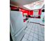 Cozy kitchen featuring white appliances, red countertops, cabinets and bright skylight at 10800 Us Highway 19 N # 143, Pinellas Park, FL 33782