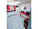 Cozy kitchen features white cabinets and red accents with a desk-like countertop at 10800 Us Highway 19 N # 143, Pinellas Park, FL 33782