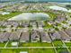 An aerial view features a community with a central lake and manicured lawns, highlighting the neighborhood's layout at 11035 Sage Canyon Dr, Riverview, FL 33578
