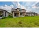 Large backyard with a covered patio, perfect for relaxing or entertaining guests at 11035 Sage Canyon Dr, Riverview, FL 33578