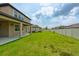 Expansive backyard with lush green grass and covered patio, great for recreation and gatherings at 11035 Sage Canyon Dr, Riverview, FL 33578