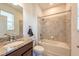 Inviting bathroom offers a granite counter, shower-over-tub and tiled floors at 11035 Sage Canyon Dr, Riverview, FL 33578