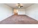 Spacious bedroom with neutral carpeting, ceiling fan, and two closets for storage and organization at 11035 Sage Canyon Dr, Riverview, FL 33578
