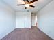 Spacious bedroom with plush carpet, a ceiling fan, closet, and bright natural light at 11035 Sage Canyon Dr, Riverview, FL 33578