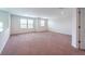 Spacious bonus room with neutral carpet, multiple windows, and bright white paint throughout at 11035 Sage Canyon Dr, Riverview, FL 33578