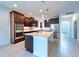 Kitchen with dark wood cabinets, large island, stainless appliances and lots of natural light at 11035 Sage Canyon Dr, Riverview, FL 33578