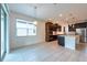Bright kitchen featuring modern appliances, a large island, dark wood cabinetry and a pendant light at 11035 Sage Canyon Dr, Riverview, FL 33578