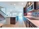 Modern kitchen features stainless steel appliances, pendant lighting and center island with sink and dishwasher at 11035 Sage Canyon Dr, Riverview, FL 33578