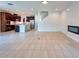 Open concept kitchen and living room with tile floors, stainless appliances, and fireplace feature wall at 11035 Sage Canyon Dr, Riverview, FL 33578