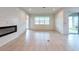 Spacious living room with neutral tile flooring, electric fireplace, and sliding glass door to outdoor space at 11035 Sage Canyon Dr, Riverview, FL 33578