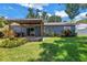 This backyard offers an open patio with wood covering, and beautiful landscaping at 11301 80Th Ave, Seminole, FL 33772