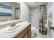 Bathroom featuring a shower, vanity, and large window, offering ample natural light at 11301 80Th Ave, Seminole, FL 33772