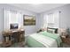 Bright bedroom with desk, chair, decorative picture, and a comfortable bed at 11301 80Th Ave, Seminole, FL 33772