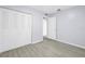 This bedroom features light grey wood-look floors and a closet with folding doors at 11301 80Th Ave, Seminole, FL 33772