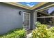 Protected entryway with a secure, decorative security door, and lush surrounding greenery at 11301 80Th Ave, Seminole, FL 33772