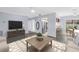 Inviting living room with a modern rug, tv, and an open layout to the kitchen and dining areas at 11301 80Th Ave, Seminole, FL 33772