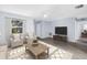 Well-lit living room with a neutral color palette, featuring a TV, and open to the kitchen at 11301 80Th Ave, Seminole, FL 33772