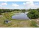 An aerial view of a property with a pond and gazebo provides serene outdoor setting at 11430 Trotting Down Dr, Odessa, FL 33556