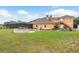 Backyard with a screened-in pool, fire pit, and outdoor space for relaxation at 11430 Trotting Down Dr, Odessa, FL 33556
