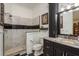 Modern bathroom with stand-up shower, classic black and white tile, and stylish vanity at 11430 Trotting Down Dr, Odessa, FL 33556
