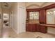 Hall bathroom featuring cherry cabinets, granite countertop, and access to bedroom at 11430 Trotting Down Dr, Odessa, FL 33556