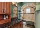 Well-appointed bathroom with granite counters, tiled tub and shower, and classic wood cabinets at 11430 Trotting Down Dr, Odessa, FL 33556