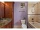 Stylish bathroom featuring a shower and soaking tub, granite counters, and wood cabinets at 11430 Trotting Down Dr, Odessa, FL 33556