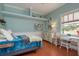 Comfortable bedroom with desk, light blue walls, and a bright window view at 11430 Trotting Down Dr, Odessa, FL 33556
