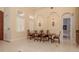 Dining room with high ceilings, elegant lighting fixtures, and beautiful windows allowing ample sunlight at 11430 Trotting Down Dr, Odessa, FL 33556
