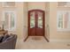 Grand front entrance with tile flooring and archways leading into the living room at 11430 Trotting Down Dr, Odessa, FL 33556