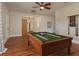 A beautiful game room featuring a wood pool table and hardwood floors at 11430 Trotting Down Dr, Odessa, FL 33556