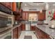 Gourmet kitchen featuring custom wood cabinetry, granite countertops and stainless steel appliances at 11430 Trotting Down Dr, Odessa, FL 33556