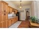 Cozy kitchenette featuring wood cabinets, granite countertops, and stainless steel refrigerator at 11430 Trotting Down Dr, Odessa, FL 33556