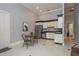 A modern kitchenette featuring stainless steel appliances, a dining table, and lots of space at 11430 Trotting Down Dr, Odessa, FL 33556