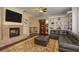 Cozy living room with a stone fireplace, plush leather sofa, and built-in shelving at 11430 Trotting Down Dr, Odessa, FL 33556