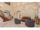 Bright living room featuring archways, hardwood stairs, and comfortable seating at 11430 Trotting Down Dr, Odessa, FL 33556
