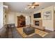 Spacious living room featuring a stone fireplace, leather sofa, and a ceiling fan at 11430 Trotting Down Dr, Odessa, FL 33556