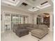 Bright living room with access to lanai, neutral decor, tile floors, and abundant natural light at 11430 Trotting Down Dr, Odessa, FL 33556