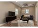 Staged living room area with ceiling fan, rug, couch, decorative pillows and window with blinds at 11430 Trotting Down Dr, Odessa, FL 33556