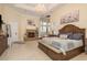 Spacious main bedroom with fireplace, chandelier, tile floor, and adjacent sitting area at 11430 Trotting Down Dr, Odessa, FL 33556
