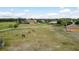 A large property with horses grazing, multiple buildings, and white fences provides a rural retreat at 11430 Trotting Down Dr, Odessa, FL 33556