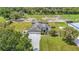 Aerial view of home and acreage featuring fenced paddocks, outbuildings and sprawling manicured lawn at 12637 Tyler Run Ave, Odessa, FL 33556