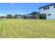 Lush green backyard highlighting the home's screened enclosure and well-kept lawn at 12637 Tyler Run Ave, Odessa, FL 33556