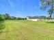 Large backyard with white fencing surrounding the property and home at 12637 Tyler Run Ave, Odessa, FL 33556