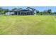 Expansive backyard featuring a screened pool and a well-maintained lawn at 12637 Tyler Run Ave, Odessa, FL 33556