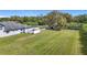 Large backyard displaying its size with pristine landscaping and fencing at 12637 Tyler Run Ave, Odessa, FL 33556
